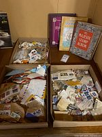 Overview showing four boxes of stamps and three albums