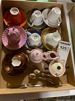 Overview of box showing five cup and saucer sets plus sugars and spoons