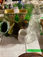 overview showing yellow vases, green glass, globe vases, bowls