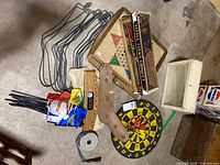 Lot overview with croquet boxes, Chinese checkers board, sock stretchers, flags, dartboard, display box