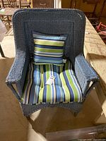 Front view of blue wicker armchair with cushions