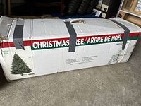 Cardboard box marked Christmas Tree/Arbre de Noël showing product image and dimensions