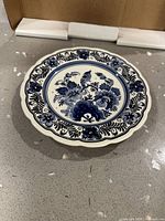 Front view of blue and white Delftware plate showing full design