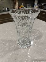Full view of clear cut crystal vase standing on countertop