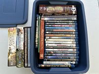 Overall shot of blue tote filled with Blu-ray and DVD cases plus several box sets standing at side