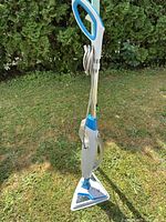 Full view of Bissell steam mop showing handle, cord, water tank and triangular cleaning head
