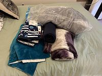 All blankets and comforter on bed