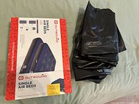 Outbound Single Air Beds 2-pack box and one folded vinyl mattress beside it