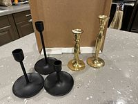 All five candlesticks together showing styles and materials