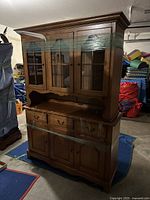 Front view showing entire two-piece china cabinet with glass doors and lower buffet