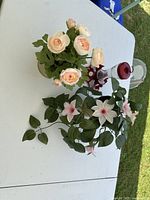 Top view showing artificial rose bouquet, trailing lily plant and hummingbird feeder on table