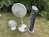 All three fans standing on grass showing overall condition and sizes