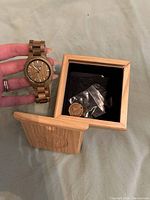 Watch held showing dial and bracelet links