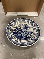 Front view of Delft plate showing floral design and scalloped rim