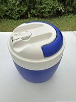Overall view of blue Igloo beverage cooler with white lid and handle