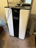 Front view of Midea portable AC showing brand, control panel, power cord