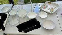 All dishware and serveware items laid out on table