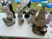 All six garden figurines arranged on table