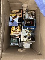 Top view of open box showing assorted DVD and Blu-ray cases