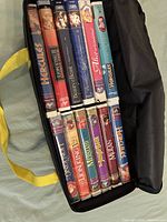Open case showing two rows of Disney VHS tapes