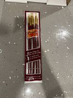 Front view of sealed Georgian Oil brush set showing six brushes in package