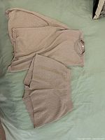 Full view of knit shirt and shorts set laid out