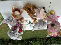 Group shot of all plush toys and frog figurines