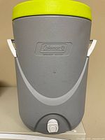 Front view showing Coleman logo, lid, handles, spigot