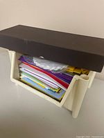 Stack of assorted colorful greeting cards stored in plastic organizer