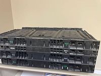 Three stacked black ventilated IFCO crates showing exterior side walls and branding