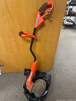 Full view of Black+Decker GrassHog corded string trimmer standing upright