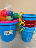 Large bucket, mesh bag of balls, stacked small buckets