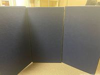 Front view of fully opened three-panel navy fabric display board
