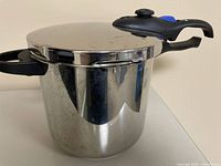 Side view of Fresco stainless steel pressure cooker with lid attached