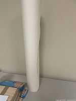 White paper roll standing on surface