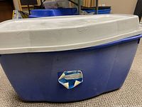 Front view of blue oval storage tub with white lid