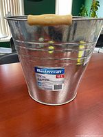 Front view of galvanized steel pail showing Mastercraft label