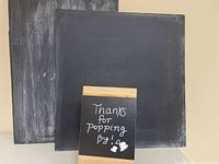 Two square chalkboards and one tabletop chalkboard sign