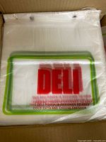 Top view of unopened stack of deli bags inside box showing print and header holes