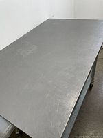 Top view of stainless steel work surface showing scratches and wear