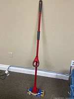 Full length view of Vileda Bee Mop showing red handle and sponge head