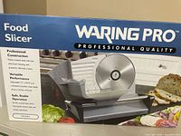 Factory box showing Waring Pro food slicer image and specs