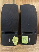 Front view of both Bose 161 speakers with grilles and Bose logos