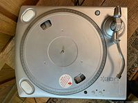Top view of silver ION TTUSB turntable lacking mat and cartridge