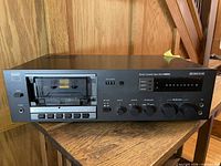 Front view showing cassette well, controls and meters