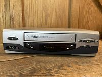 Front view of RCA VR457HF VCR showing branding, controls and tape slot