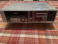 Front angle of Sanyo Betahi-fi VCR model 7200 on plaid surface