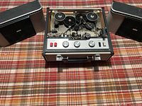 Recorder with speakers detached, tape transport and control panel visible