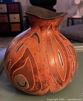 angled view showing carved motifs and overall form