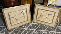 Both framed horse prints side by side showing full frames and mats